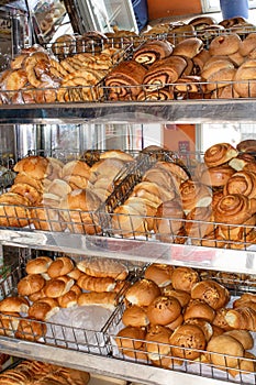 Freshly baked bread, shelves with buns on the display case. Quito, Ecuador