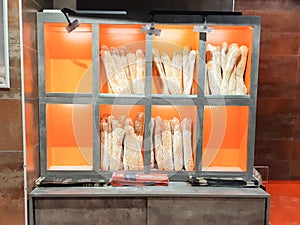 Freshly baked breads baguette stand in French bakery