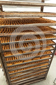 Freshly baked breadsticks taken out of oven.