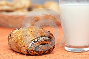 Freshly baked bun with poppyseeds and milk