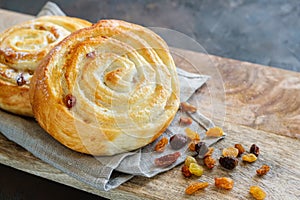 Freshly baked bun with raisins on a napkin