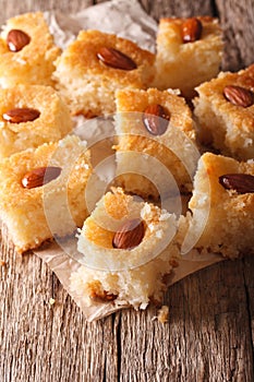 Freshly baked cake with almonds basbousa close-up. vertical