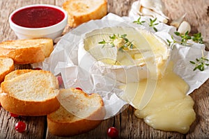 Freshly baked Camembert cheese with garlic, thyme served with to