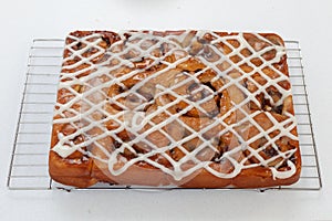 Freshly baked chelsea buns on a wire cooling rack - viewed from