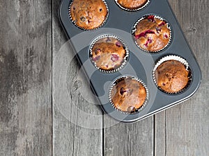 Freshly baked cherry muffins closeup in baking tray