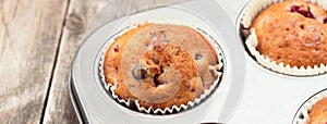 Freshly baked cherry muffins closeup in baking tray