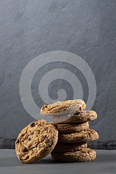 Freshly baked Chocolate chip cookies on a dark stone with place for text