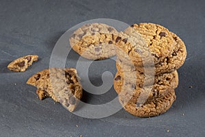 Freshly baked Chocolate chip cookies on a dark stone with place for text