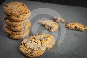 freshly baked Chocolate chip cookies on a dark stone with place for text