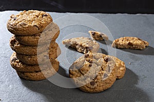 freshly baked Chocolate chip cookies on a dark stone with place for text