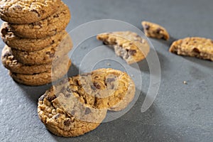 freshly baked Chocolate chip cookies on a dark stone with place for text