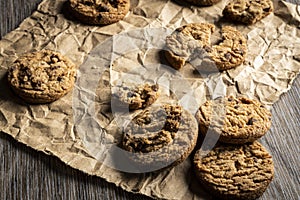 Freshly baked Chocolate chip cookies on a wooden table with place for text.