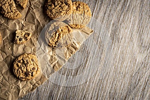 Freshly baked Chocolate chip cookies on a wooden table with place for text