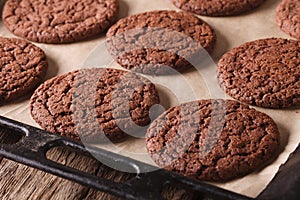 Freshly baked chocolate cookies on a baking sheet close-up. Horizontal