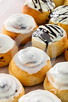 Freshly baked cinnabons rolls with sweet glaze. Homemade cinnamon buns