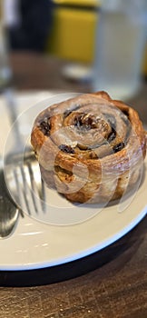 freshly baked Cinnamon rolls or cinnamon bun with raisins and vanilla also icing sugar ridiculously good