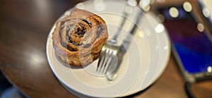 freshly baked Cinnamon rolls or cinnamon bun with raisins and vanilla also icing sugar ridiculously good