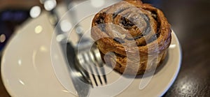 freshly baked Cinnamon rolls or cinnamon bun with raisins and vanilla also icing sugar ridiculously good