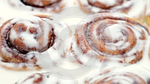 Freshly baked cinnamon rolls with frosting close up