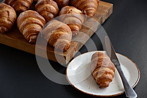 The freshly baked croissants on black background. Flat style