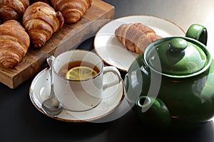 The freshly baked croissants on black background. Flat style