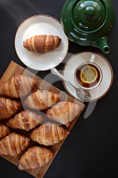 The freshly baked croissants on black background. Flat style