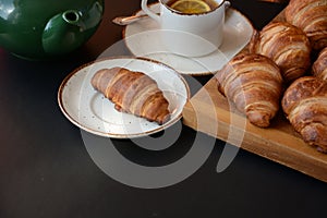 The freshly baked croissants on black background. Flat style