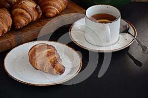 The freshly baked croissants on black background. Flat style