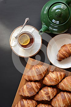 The freshly baked croissants on black background. Flat style