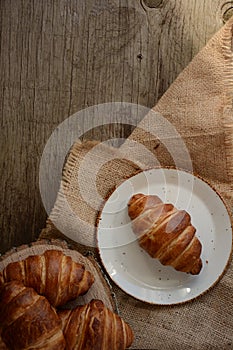 The freshly baked croissants on black background. Flat style