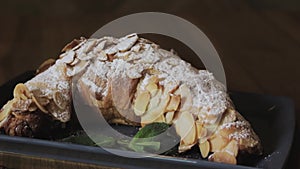 Freshly baked croissants, mint leaves and cup of coffee on wooden board, top view, selective focus