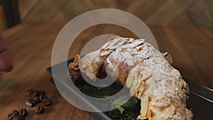 Freshly baked croissants, mint leaves and cup of coffee on wooden board, top view, selective focus