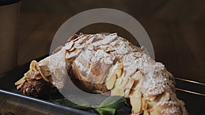 Freshly baked croissants, mint leaves and cup of coffee on wooden board, top view, selective focus