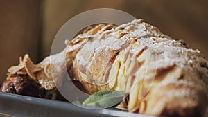 Freshly baked croissants, mint leaves and cup of coffee on wooden board, top view, selective focus