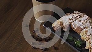 Freshly baked croissants, mint leaves and cup of coffee on wooden board, top view, selective focus