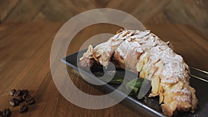 Freshly baked croissants, mint leaves and cup of coffee on wooden board, top view, selective focus