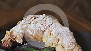 Freshly baked croissants, mint leaves and cup of coffee on wooden board, top view, selective focus