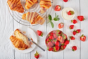 Freshly baked croissants with ripe berries