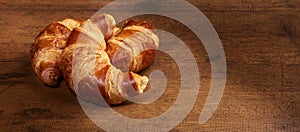 Freshly baked croissants on wooden cutting board, close-up