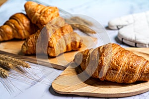 Home made freshly baked croissants on wooden cutting board