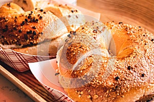 Freshly baked, crunchy typical NYC bagels with sesame, poppyseed topping, cream cheese spread and lox from coffee shop