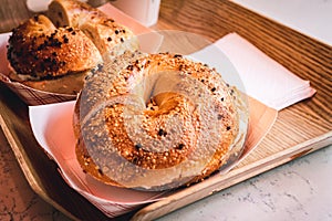 Freshly baked, crunchy typical NYC bagels with sesame, poppyseed topping, cream cheese spread and lox from coffee shop