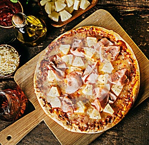 Freshly baked crusty ham and pineapple pizza