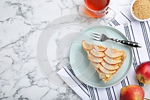 Freshly baked delicious apple pie served on white marble table, flat lay. Space for text