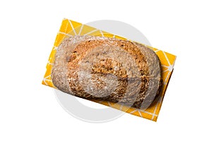 Freshly baked delicious french bread with napkin isolated on white background top view. Healthy white bread loaf