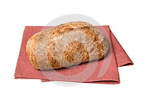 Freshly baked delicious french bread with napkin isolated on white background top view. Healthy white bread loaf