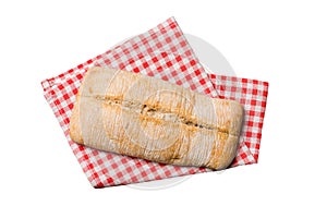 Freshly baked delicious french bread with napkin isolated on white background top view. Healthy white bread loaf