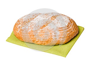 Freshly baked delicious french bread with napkin isolated on white background top view. Healthy white bread loaf