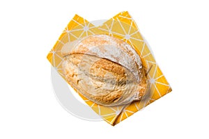 Freshly baked delicious french bread with napkin isolated on white background top view. Healthy white bread loaf