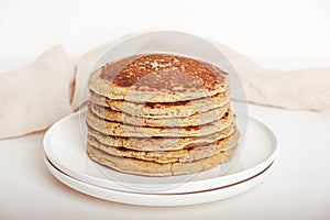 Freshly baked farinata pancakes on white background.